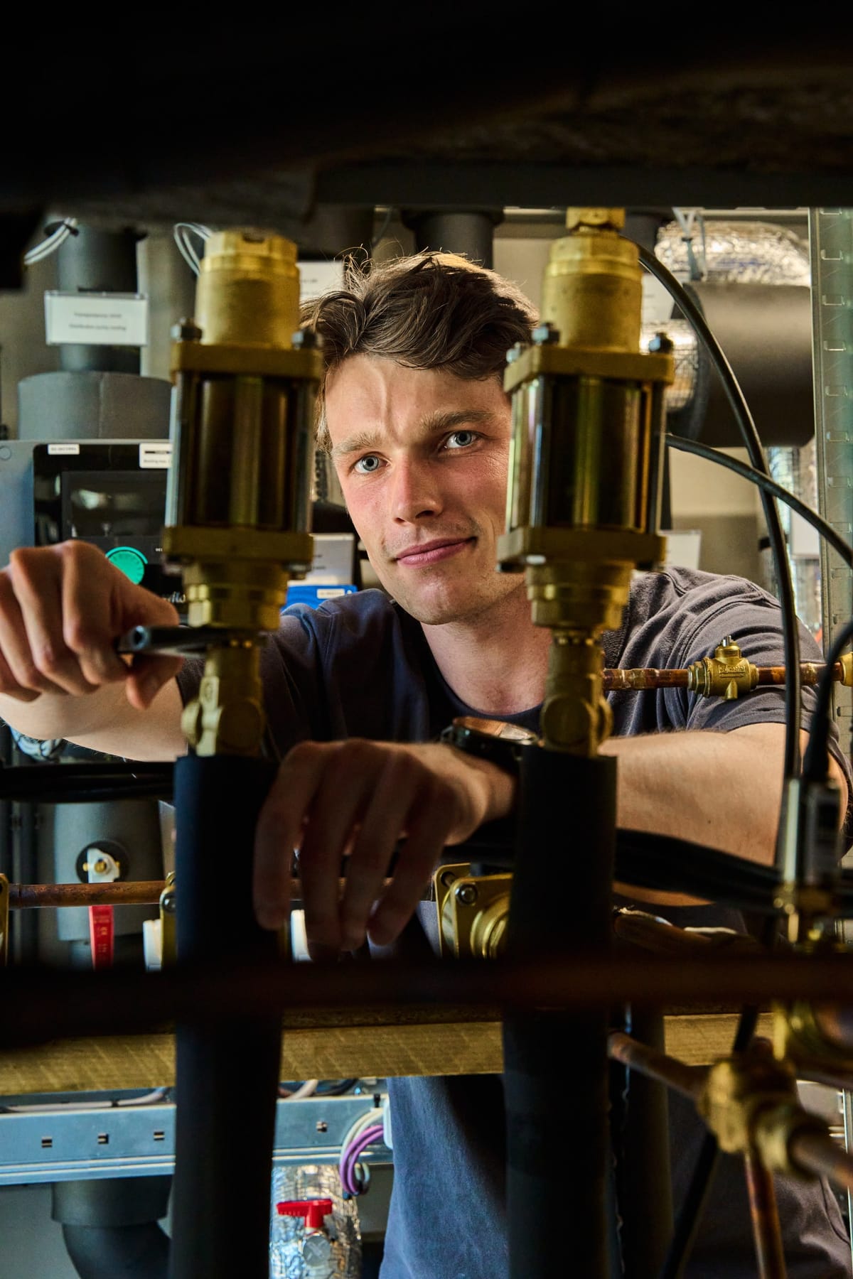 Martijn Oortwijn adjusting a valve on the Expantec test rig, seen between two brass valve bodies
